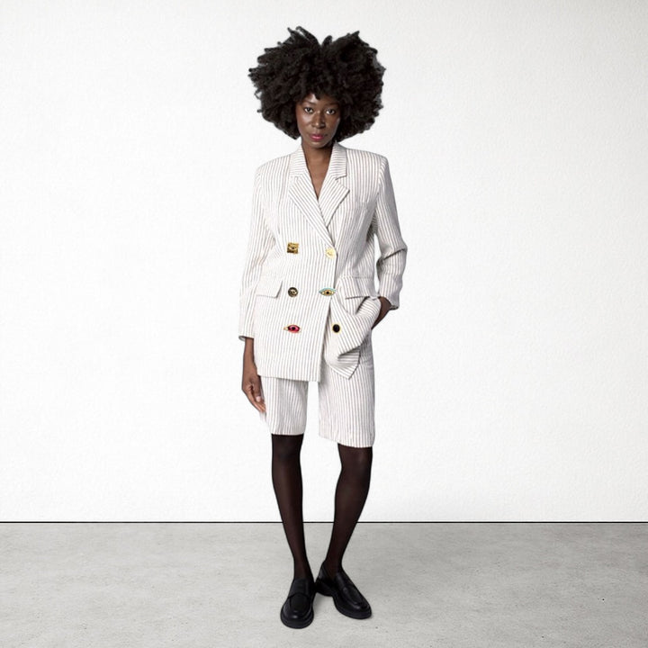 Ivory pin stripe linen double breasted suit with surrealist eye buttons